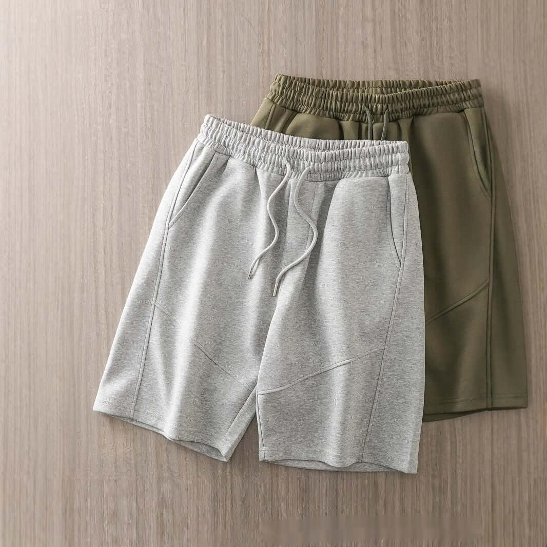 pantalones cortos casuales pesados para hombres en colores gris y oliva sobre fondo de madera